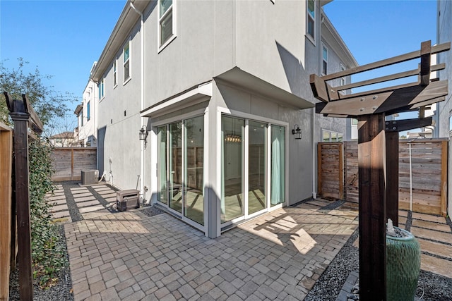 view of patio / terrace with central air condition unit, a fenced backyard, and a pergola