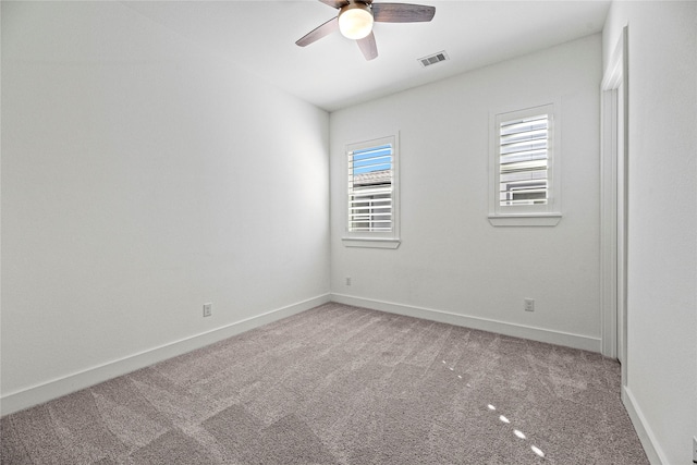 unfurnished room featuring ceiling fan, carpet, visible vents, and baseboards