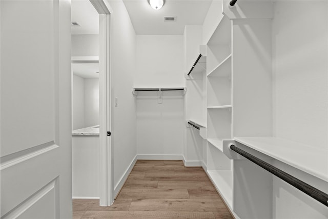 walk in closet featuring visible vents and light wood finished floors