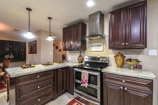 kitchen with range with two ovens, light stone counters, dark brown cabinetry, wall chimney range hood, and a peninsula