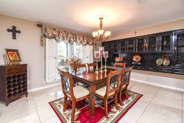 dining room with baseboards, an inviting chandelier, and light tile patterned floors