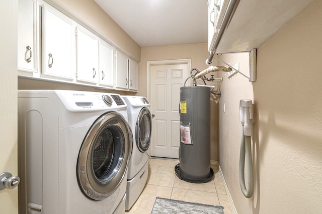 laundry area with independent washer and dryer, light tile patterned flooring, cabinet space, and electric water heater