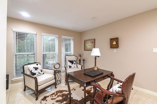 home office with light tile patterned floors and baseboards