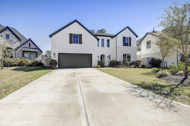 view of front of property with a garage, driveway, and a front yard