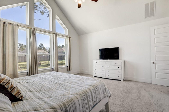 carpeted bedroom with visible vents, ceiling fan, baseboards, and lofted ceiling