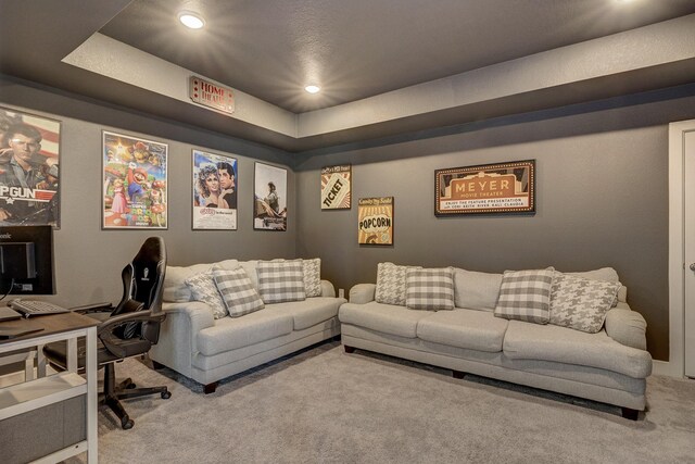 carpeted cinema featuring a tray ceiling and recessed lighting