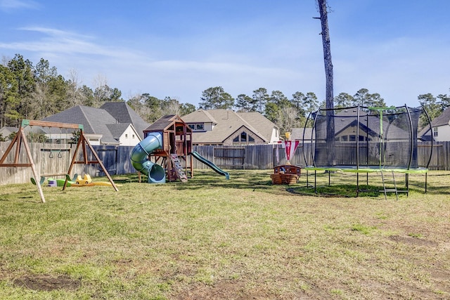 view of yard with a playground, a trampoline, and a fenced backyard