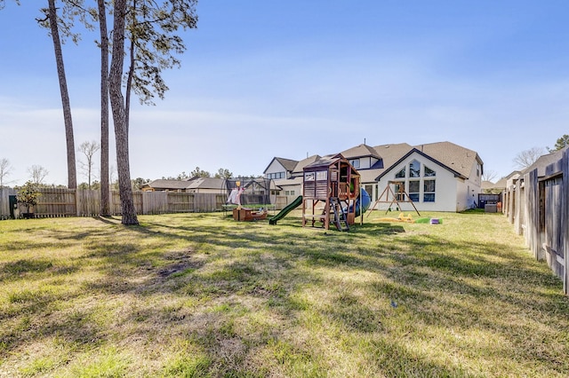 view of yard with a playground and a fenced backyard