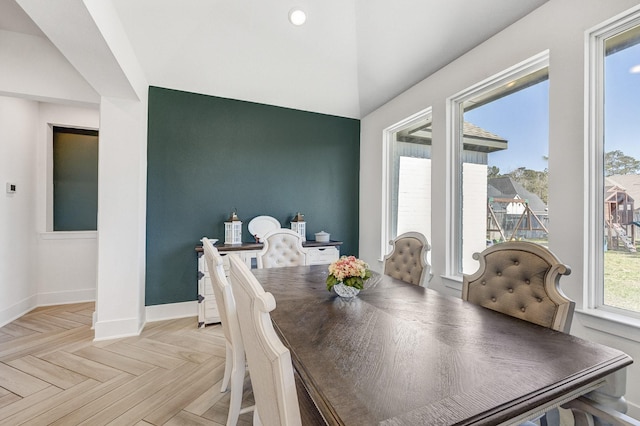 dining space featuring baseboards and plenty of natural light