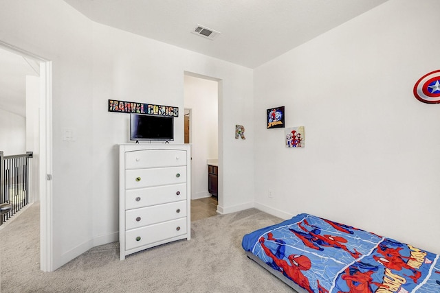 bedroom featuring baseboards, visible vents, and light carpet