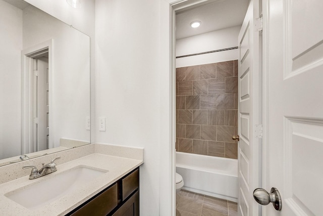 bathroom with tub / shower combination, toilet, vanity, and tile patterned flooring