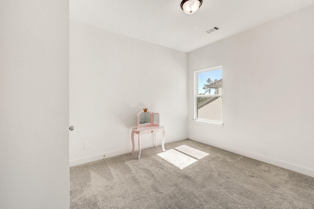 spare room with visible vents, baseboards, and carpet flooring