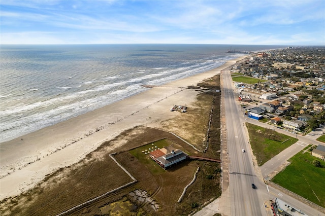 drone / aerial view with a water view and a beach view