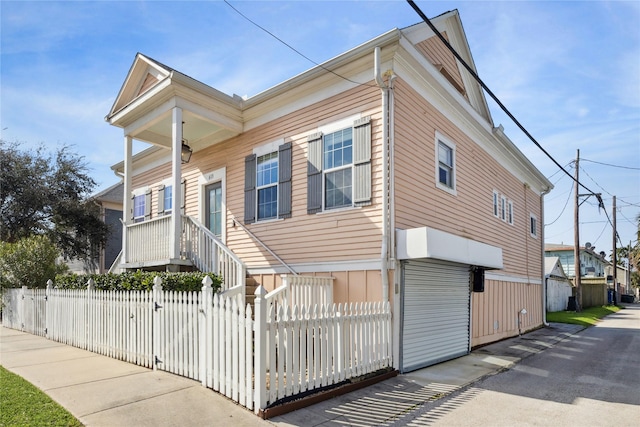 view of front of house with a fenced front yard and a gate