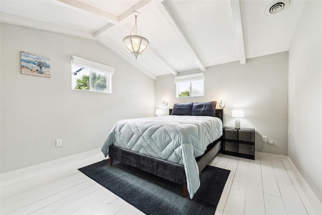 bedroom featuring lofted ceiling with beams, light wood-style floors, visible vents, and baseboards