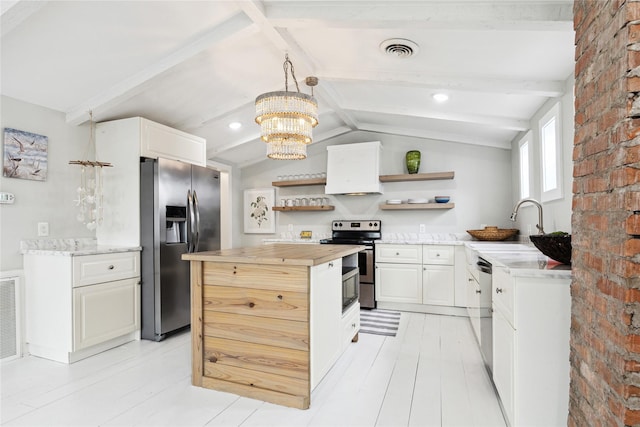 kitchen featuring visible vents, vaulted ceiling with beams, butcher block countertops, appliances with stainless steel finishes, and open shelves