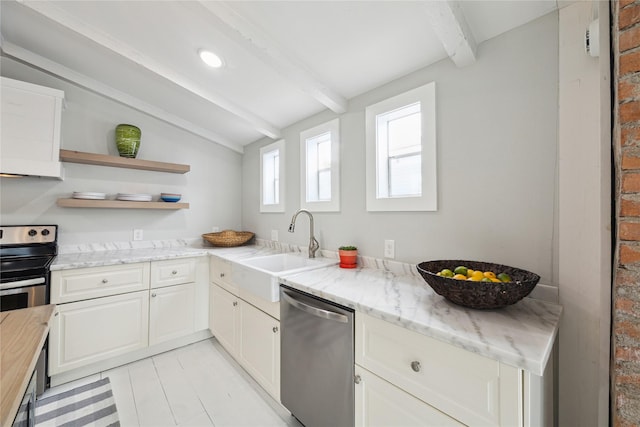 kitchen featuring lofted ceiling with beams, open shelves, a sink, appliances with stainless steel finishes, and white cabinets