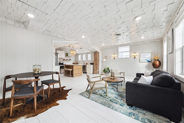 living room with visible vents and light wood-type flooring