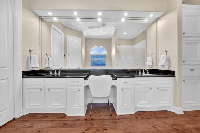 438 S Burnett Dr, Baytown, TX 77520 - bathroom with double vanity, a ceiling fan, a sink, and wood finished floors
