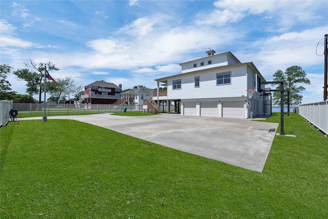 438 S Burnett Dr, Baytown, TX 77520 - exterior space with driveway, a garage, stairway, fence, and a front yard