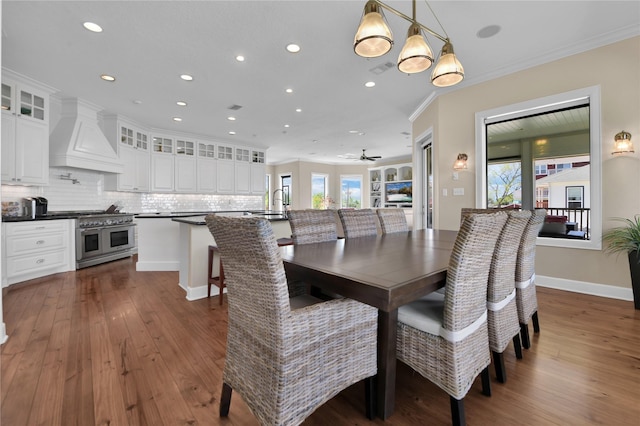 438 S Burnett Dr, Baytown, TX 77520 - dining area with baseboards, ornamental molding, dark wood-style flooring, and recessed lighting