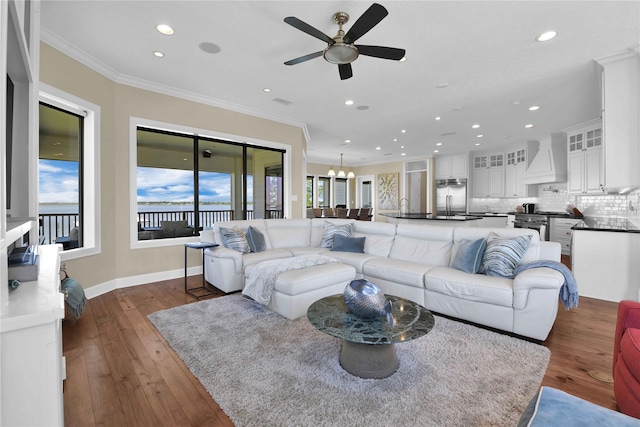 438 S Burnett Dr, Baytown, TX 77520 - living room featuring recessed lighting, baseboards, dark wood-type flooring, crown molding, and ceiling fan with notable chandelier