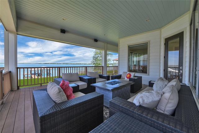 438 S Burnett Dr, Baytown, TX 77520 - wooden deck featuring an outdoor living space with a fire pit and a water view