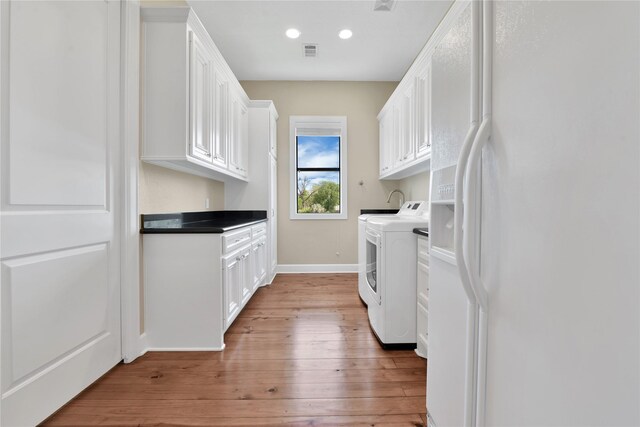 438 S Burnett Dr, Baytown, TX 77520 - laundry room featuring cabinet space, visible vents, independent washer and dryer, light wood-type flooring, and recessed lighting