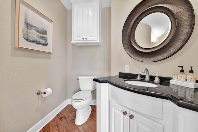 438 S Burnett Dr, Baytown, TX 77520 - half bath with baseboards, vanity, toilet, and wood finished floors