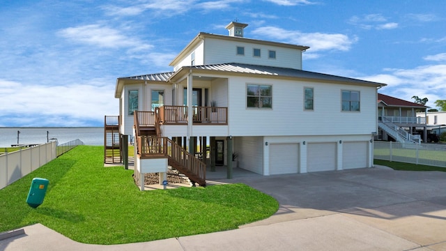 view of front of home with a front lawn, fence, stairway, and an attached garage