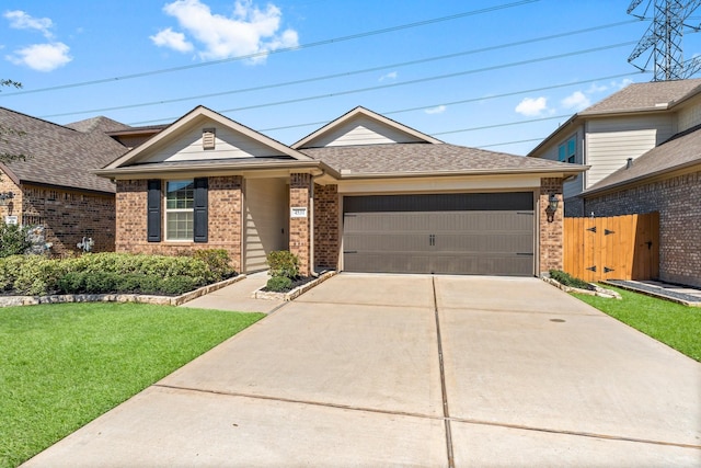 single story home with driveway, an attached garage, fence, a front lawn, and brick siding