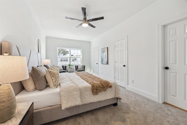 carpeted bedroom featuring crown molding, a ceiling fan, and baseboards