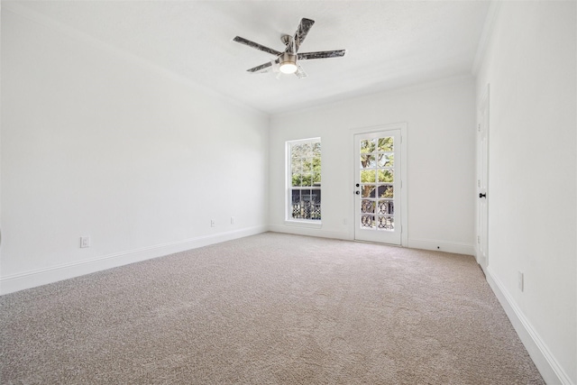 unfurnished room featuring light colored carpet, ceiling fan, and baseboards