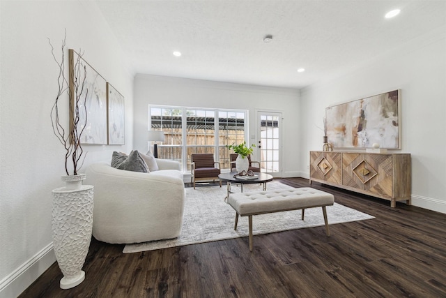 living area with recessed lighting, baseboards, and wood finished floors