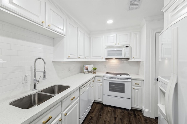 kitchen featuring white appliances, dark wood-style flooring, a sink, visible vents, and white cabinets