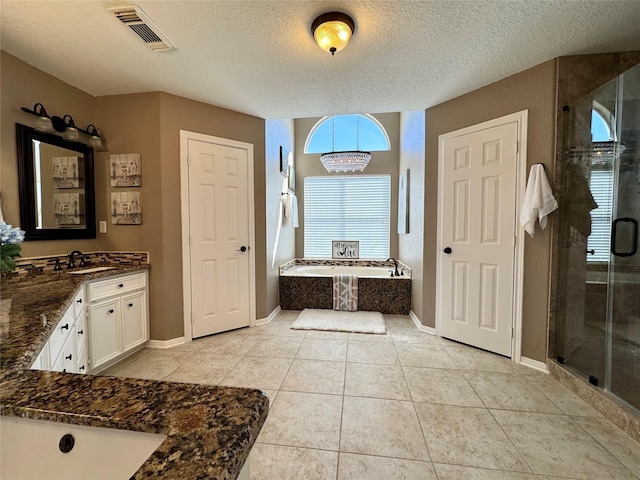 full bath featuring visible vents, a textured ceiling, a garden tub, and a stall shower
