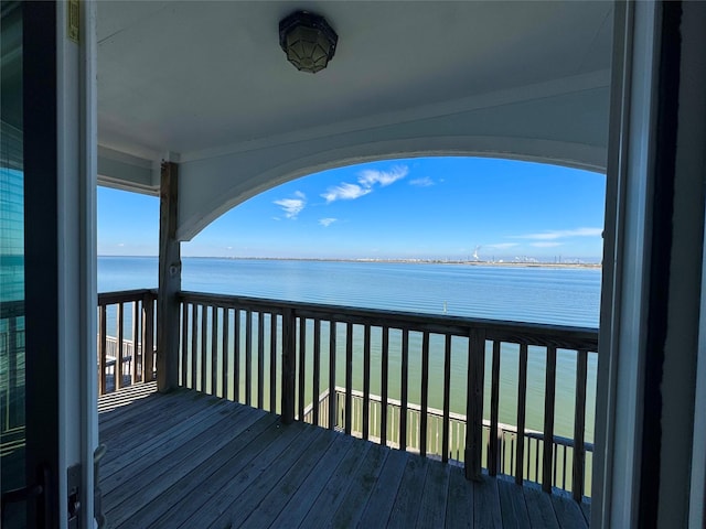 wooden terrace featuring a water view