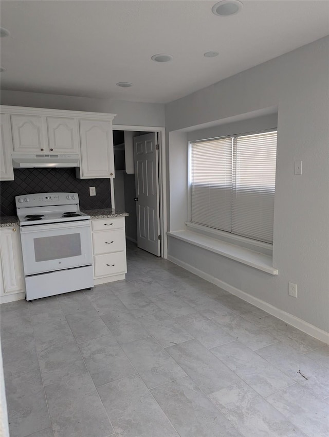 kitchen featuring white electric stove, tasteful backsplash, white cabinetry, under cabinet range hood, and baseboards