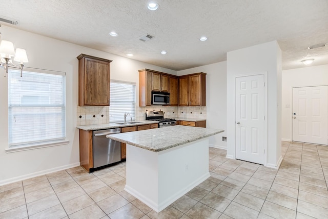 kitchen with visible vents, appliances with stainless steel finishes, backsplash, and light tile patterned flooring