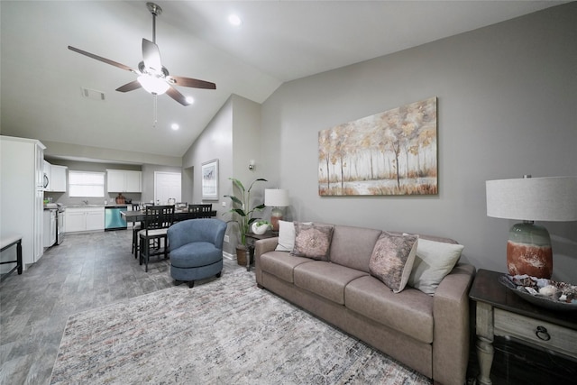 living area with visible vents, lofted ceiling, ceiling fan, light wood-type flooring, and recessed lighting