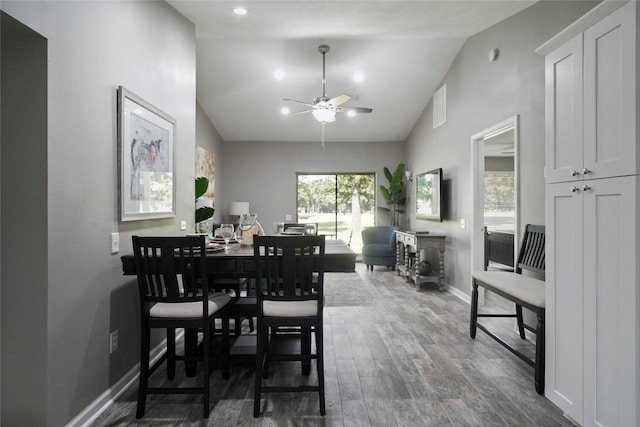 dining space featuring recessed lighting, dark wood-type flooring, vaulted ceiling, ceiling fan, and baseboards