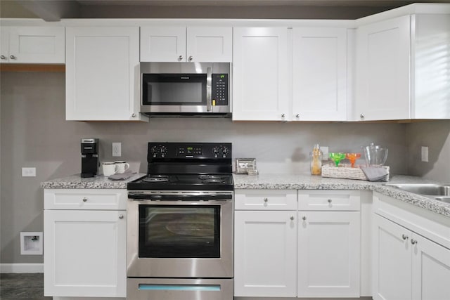 kitchen featuring appliances with stainless steel finishes and white cabinetry