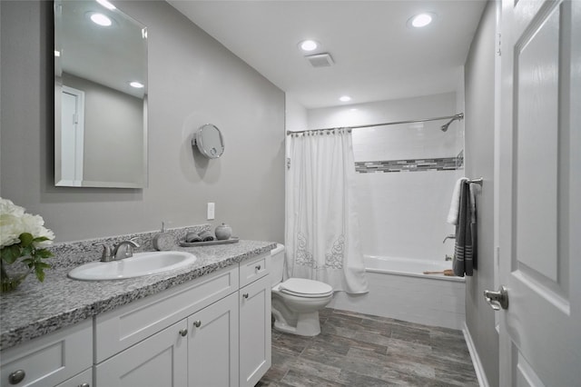 full bath featuring toilet, recessed lighting, tiled shower / bath combo, wood finish floors, and vanity