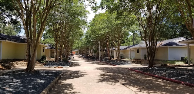 view of road featuring curbs, street lighting, and a residential view