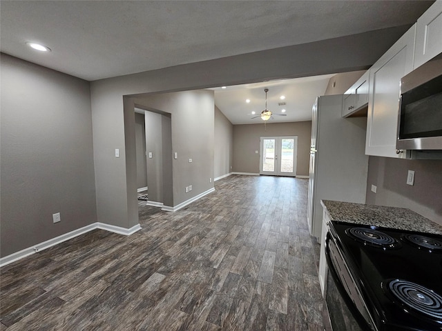 interior space featuring stainless steel appliances, dark wood-type flooring, baseboards, white cabinets, and french doors