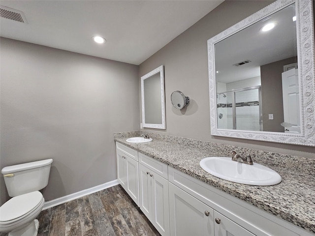 full bath with toilet, a stall shower, a sink, and visible vents