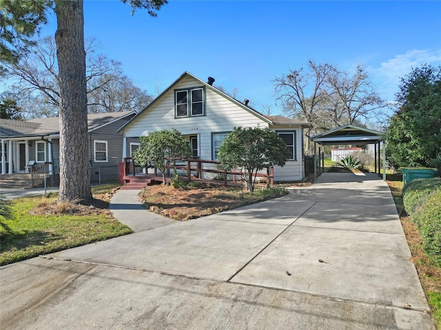 bungalow-style house featuring covered porch, a carport, and concrete driveway