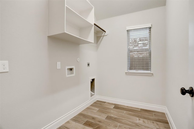 washroom with hookup for a gas dryer, laundry area, wood finish floors, baseboards, and electric dryer hookup