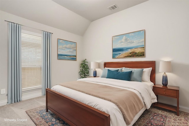 bedroom with light colored carpet, visible vents, vaulted ceiling, and baseboards