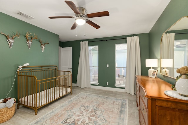 bedroom featuring a ceiling fan, light wood-type flooring, and visible vents